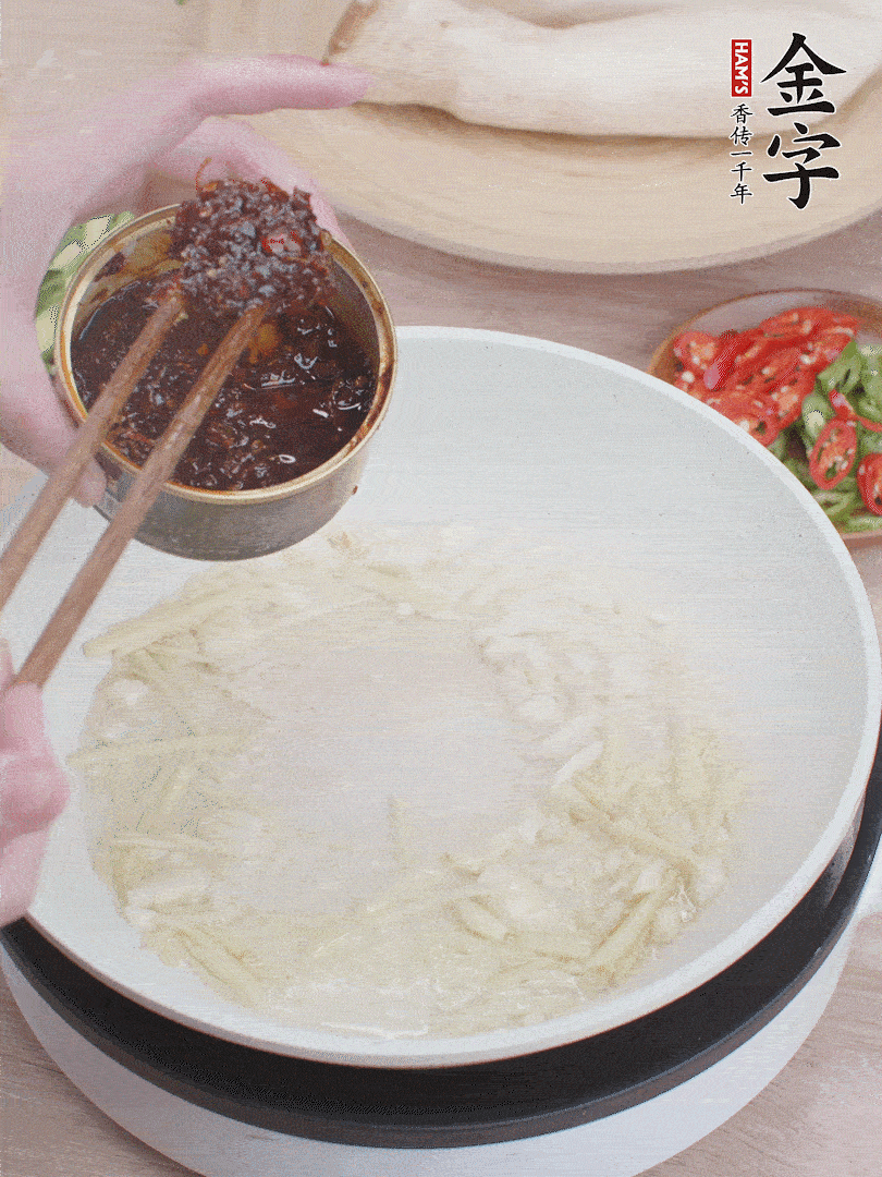 起鍋熱油，姜蒜、金字火腿干貝醬煸香。